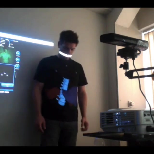 Live projection onto a person, with the Kinect infrared camera and projector rig in view